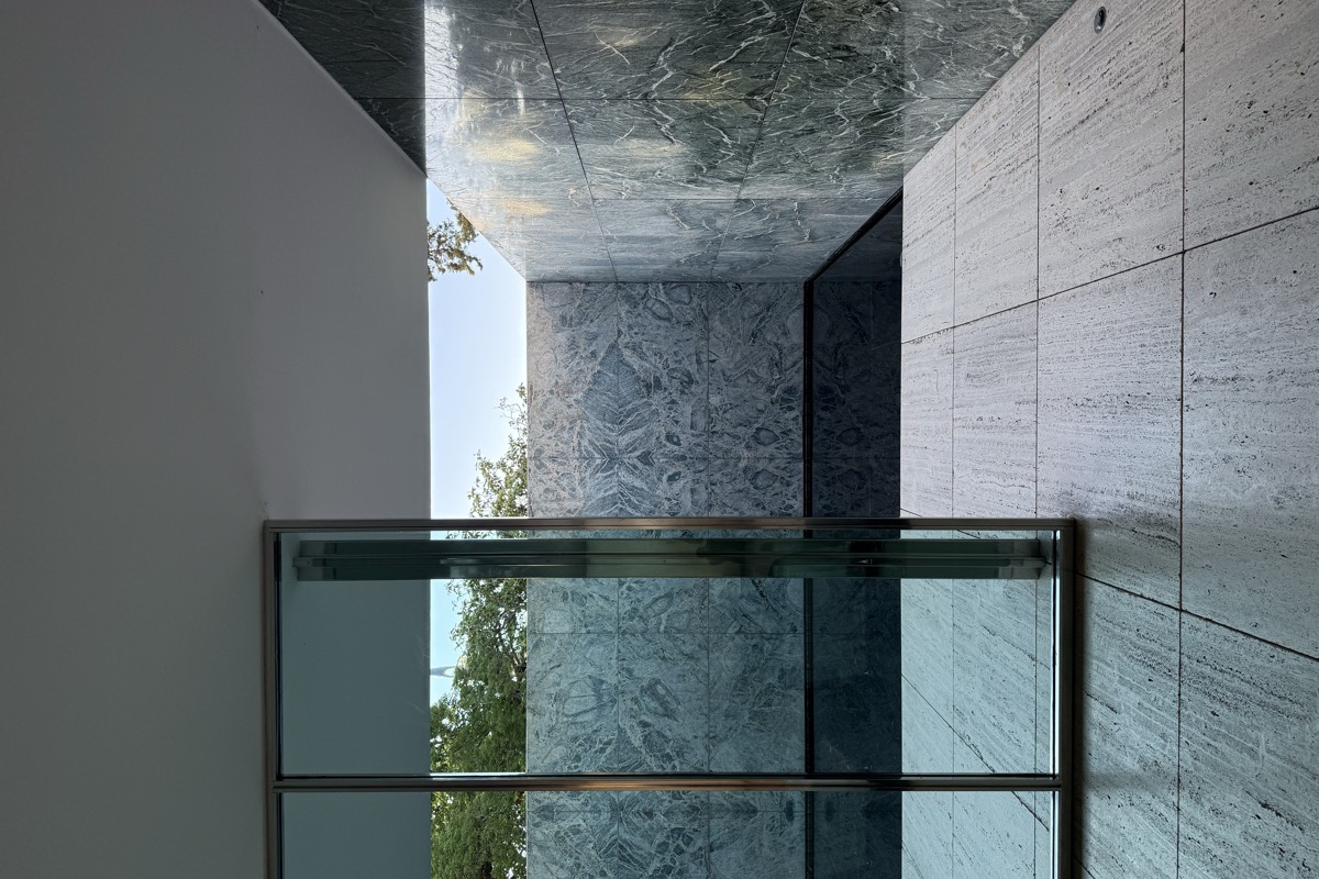 Travertine walls, reflecting pool and open plan of the Mies van der Rohe Barcelona Pavilion